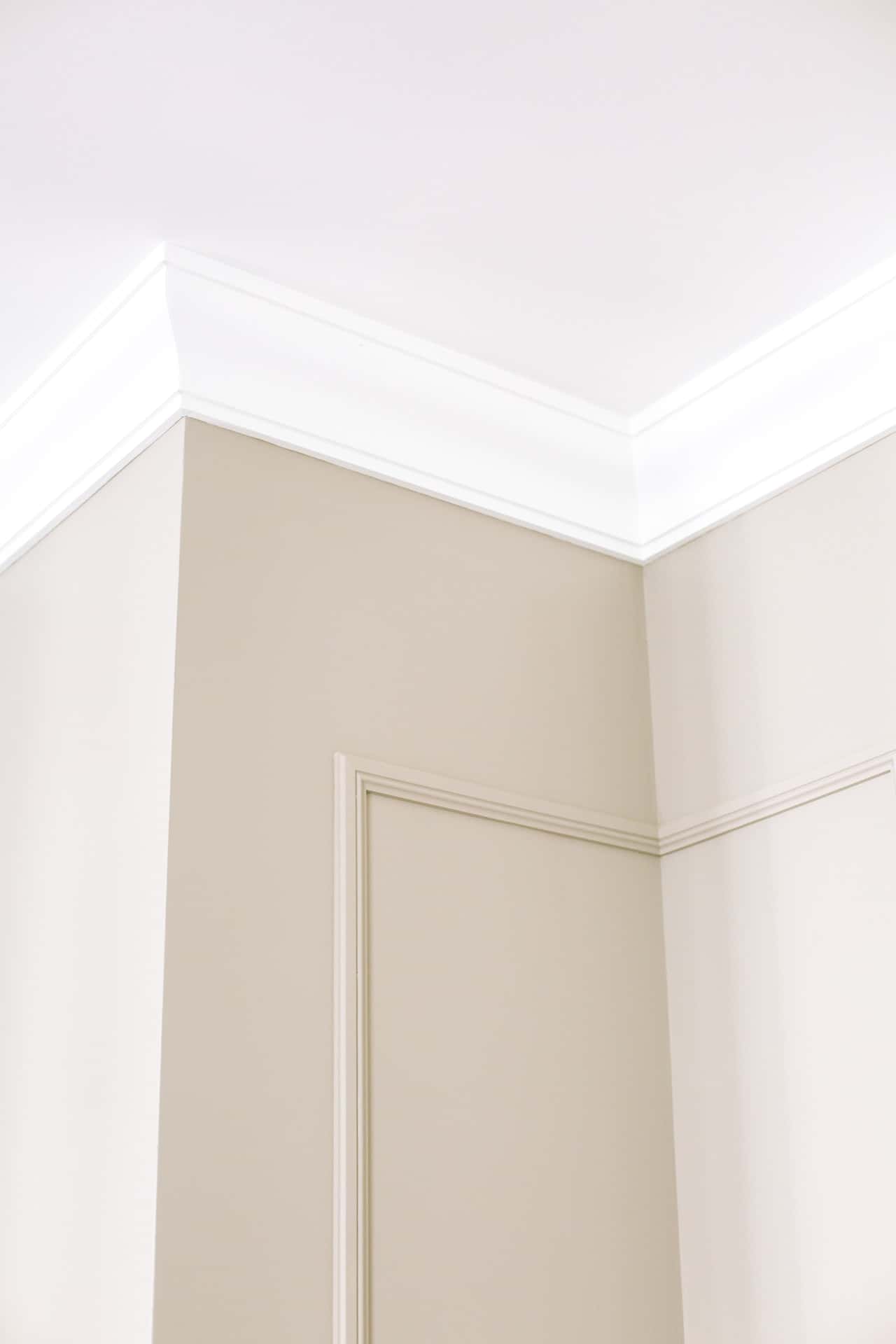 Clean pop design for ceiling with elegant white cornices and beige wall panels