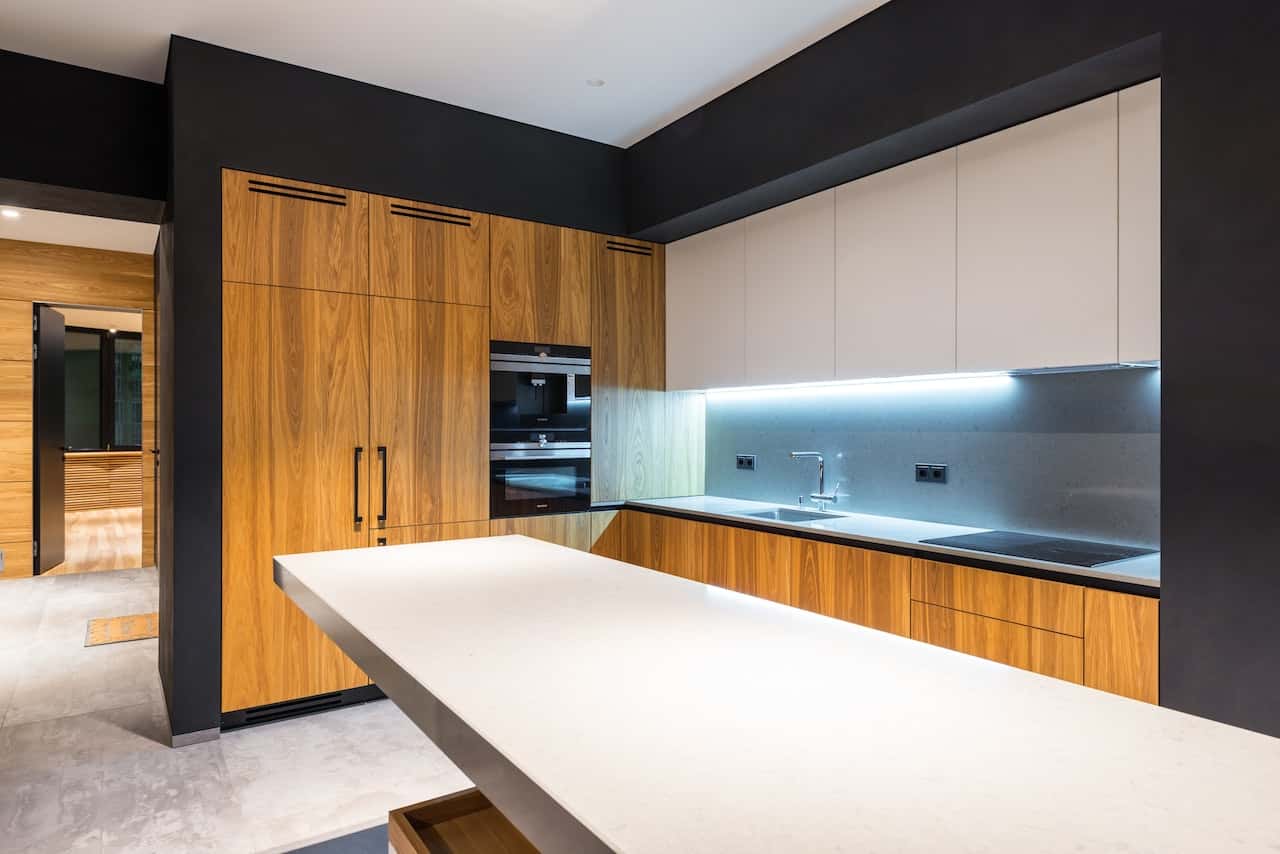 Modern kitchen entrance design with wooden cabinets and white counters