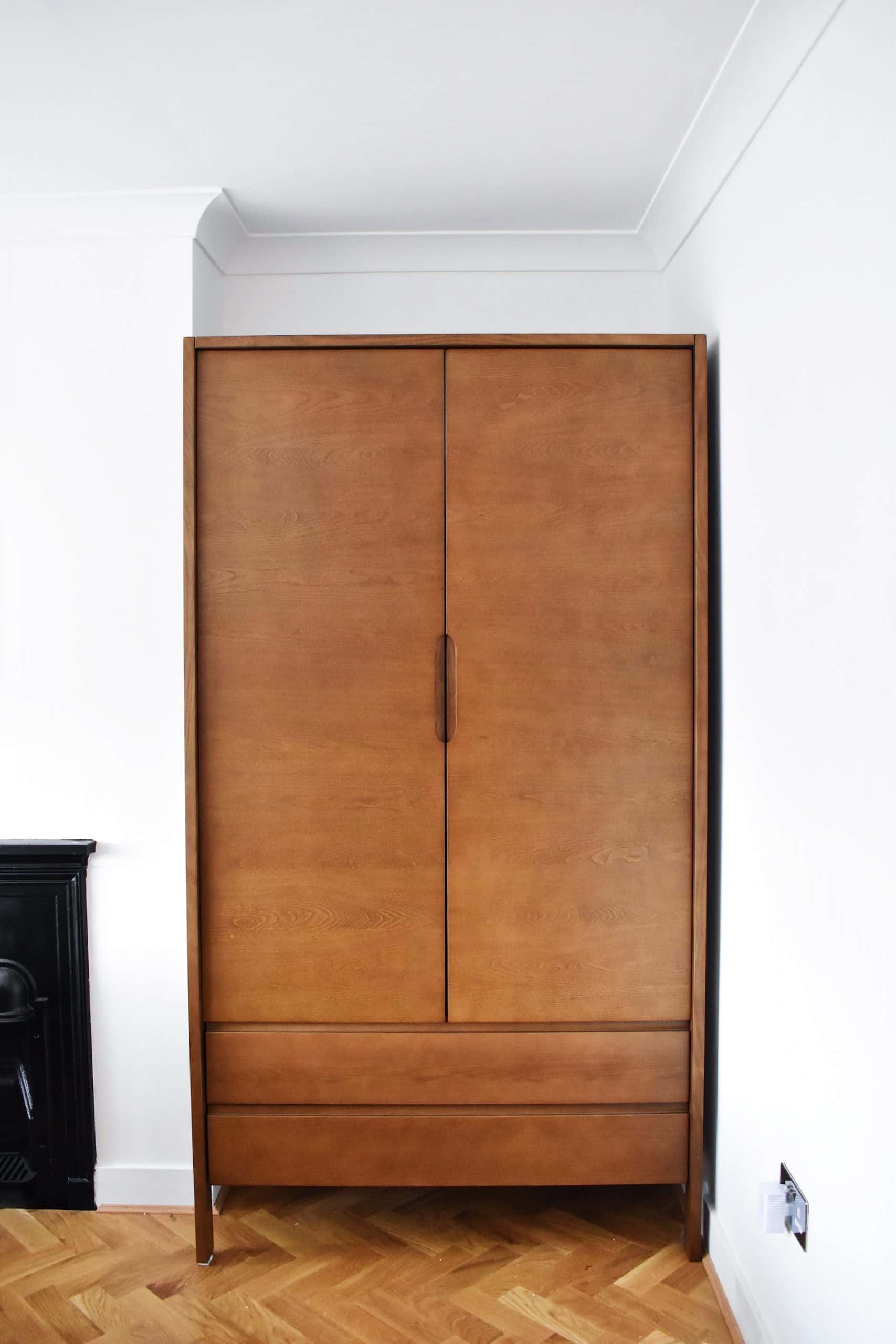 wooden storage cabinet with folding bed inside