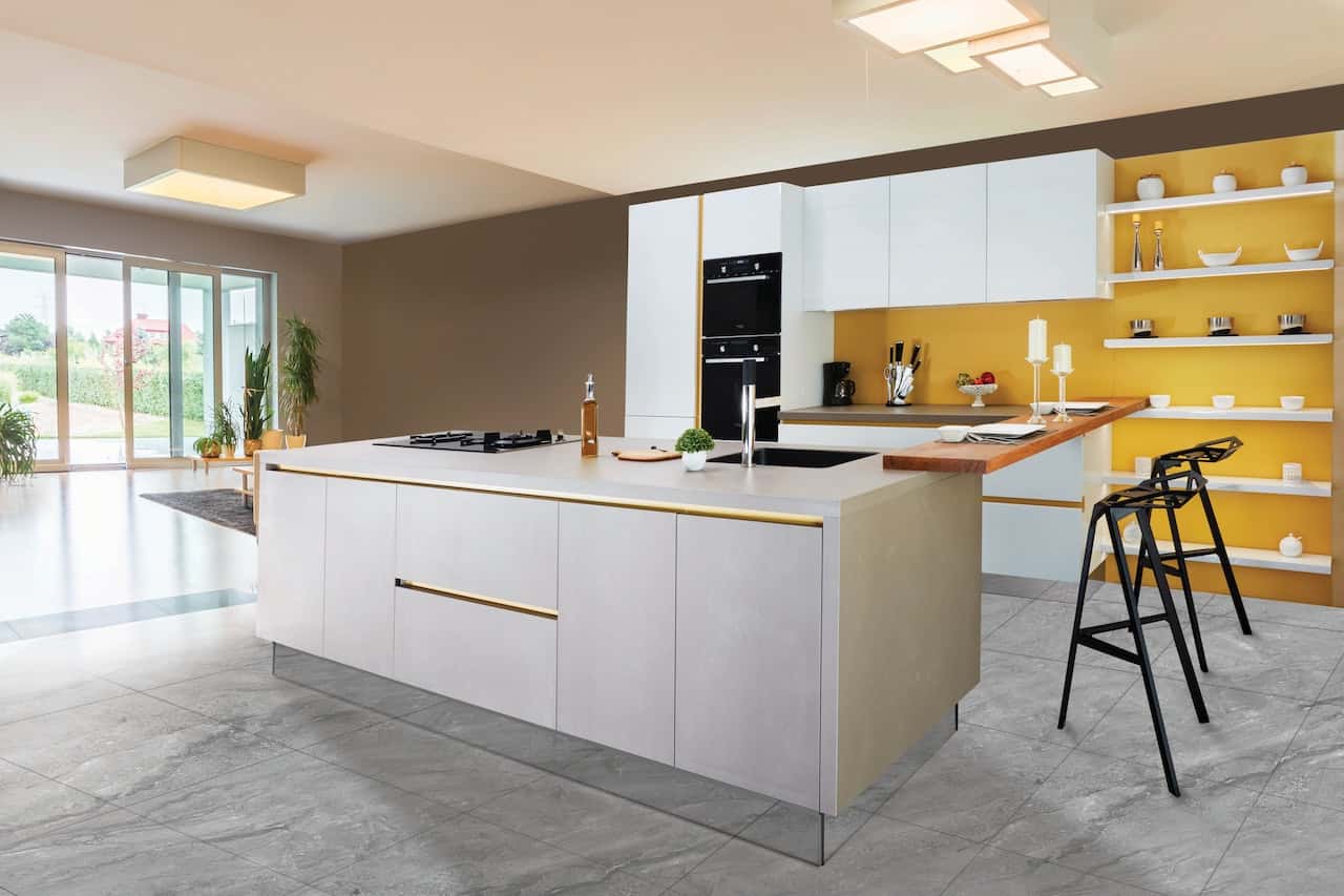 Modern gola profile handles in an open kitchen with yellow accent wall and island