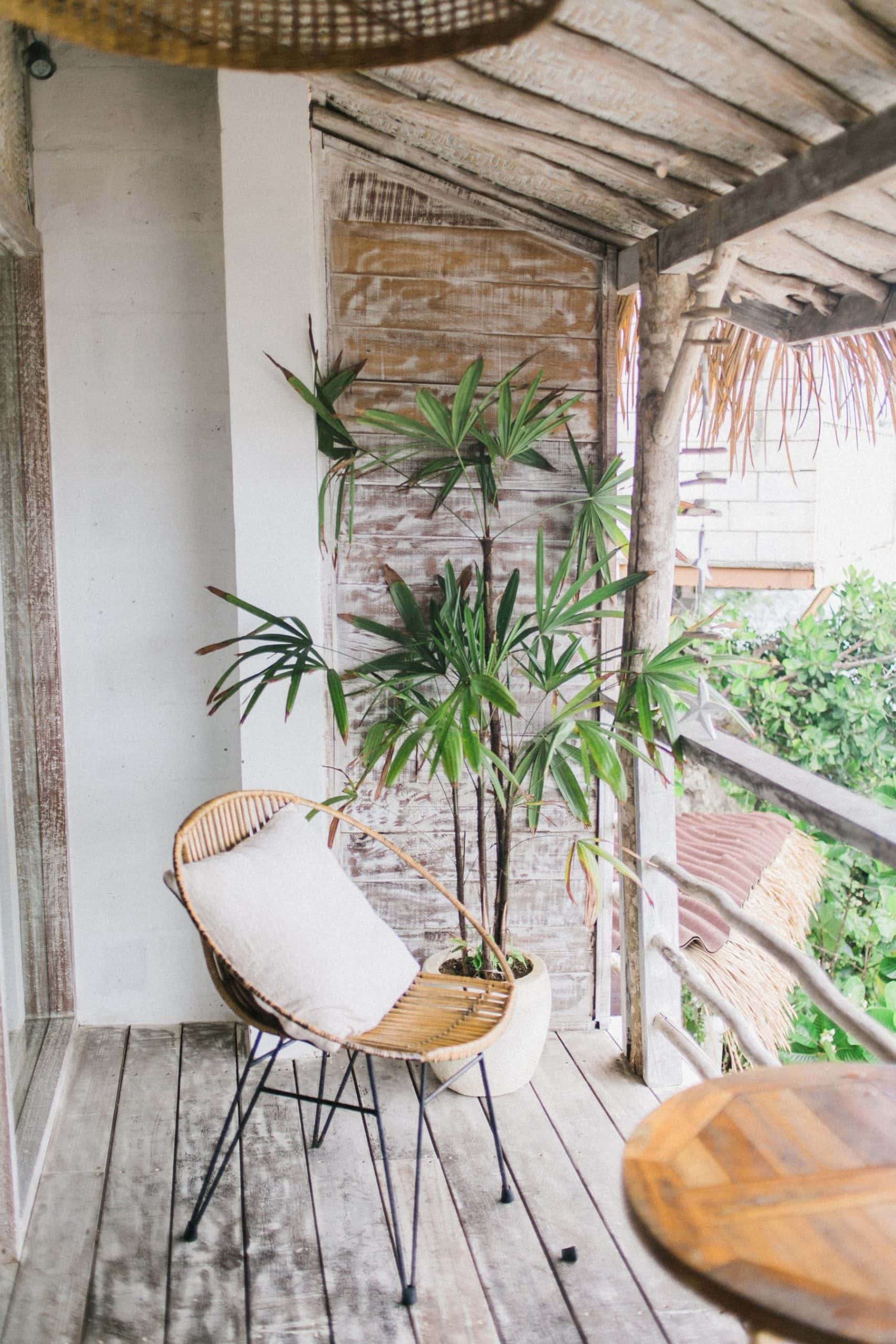 Tropical closed balcony ideas with wood tones, greens, and cozy seating