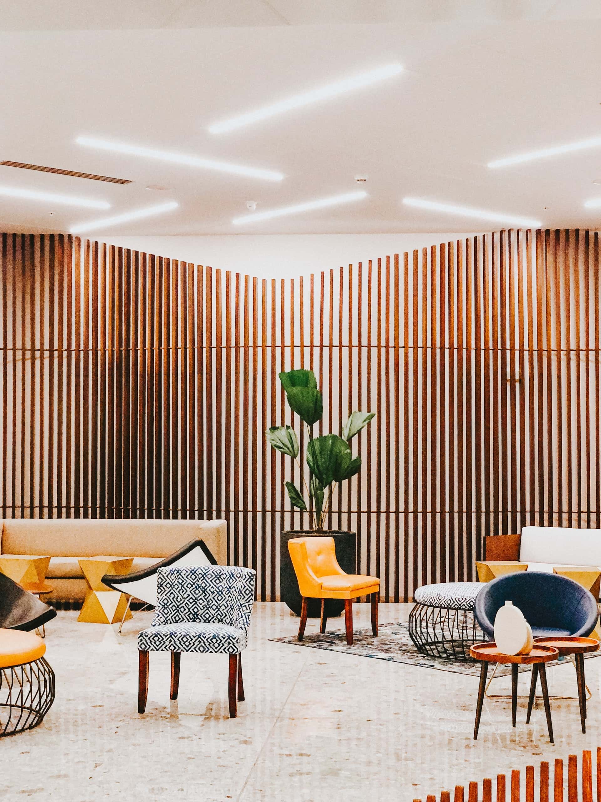 Modern lounge with vertical wooden wall moulding designs and eclectic seating