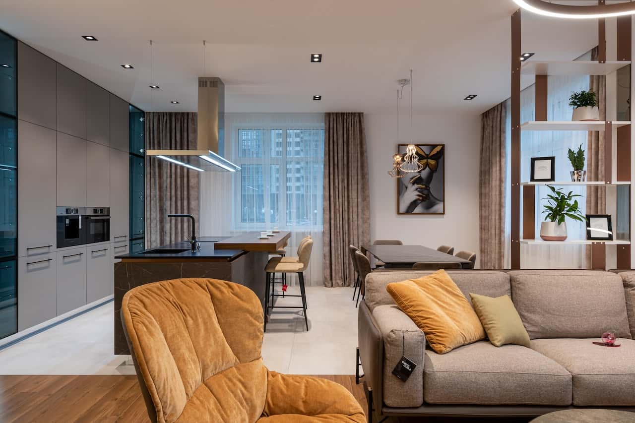Modern fiber ceiling designs elevate this open living and kitchen space beautifully