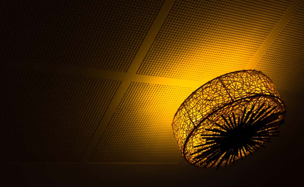 Warm ceiling light with fiber ceiling designs and intricate grid pattern