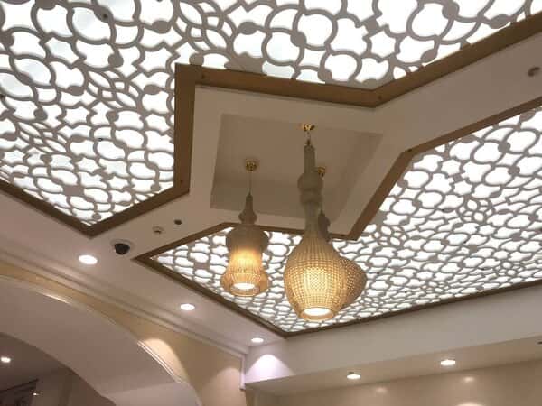Glass ceiling design ideas with ornate patterns and luxury hanging lamps