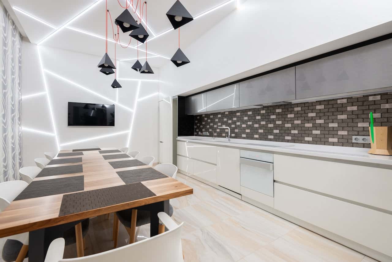 Contemporary glass modular kitchen with creative lighting and tiled backsplash
