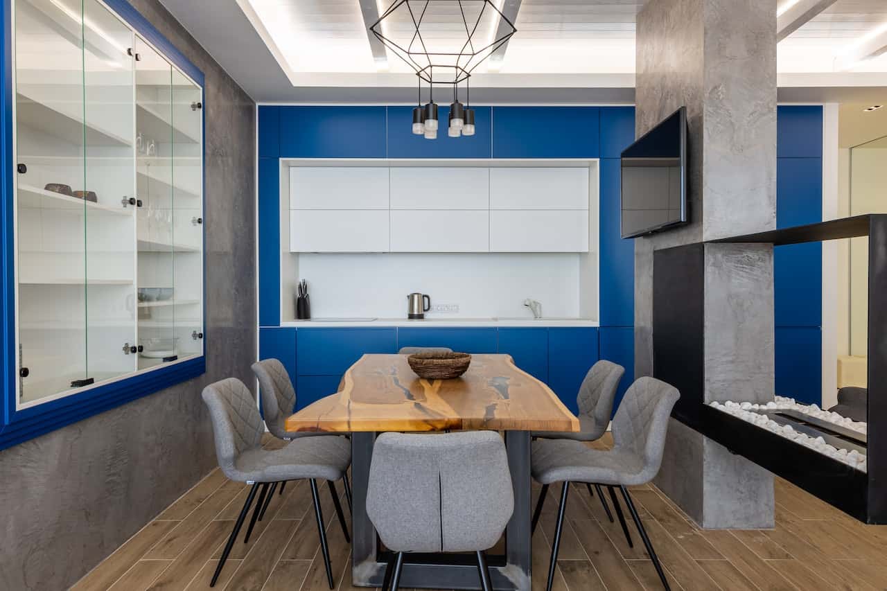 Modern cement cupboard designs in kitchen with blue and white storage units