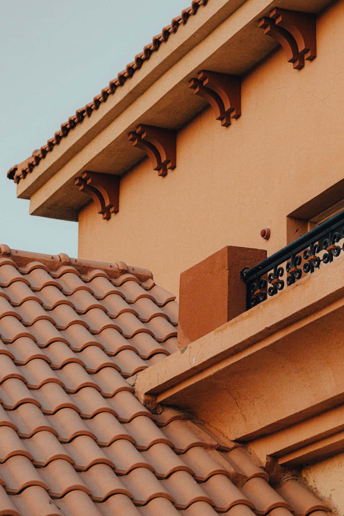 Detailed mangalore tile roof close-up with warm terracotta tones and arched supports