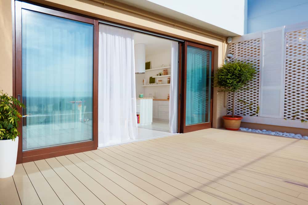 Sliding elevation glass designs with wooden frames for balcony and kitchen access