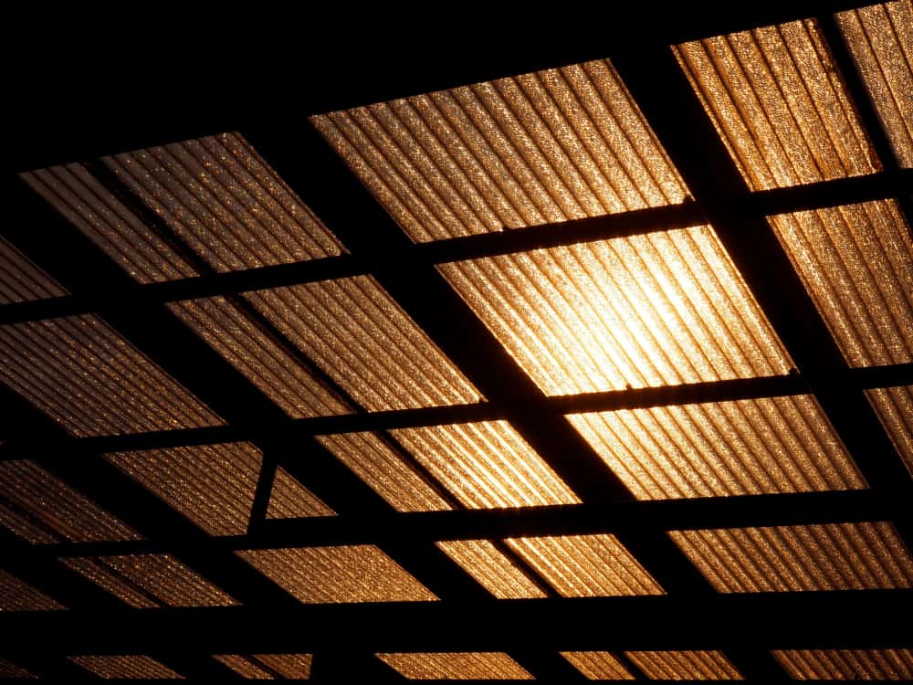 Sunlit polycarbonate roof design with golden glow and grid structure