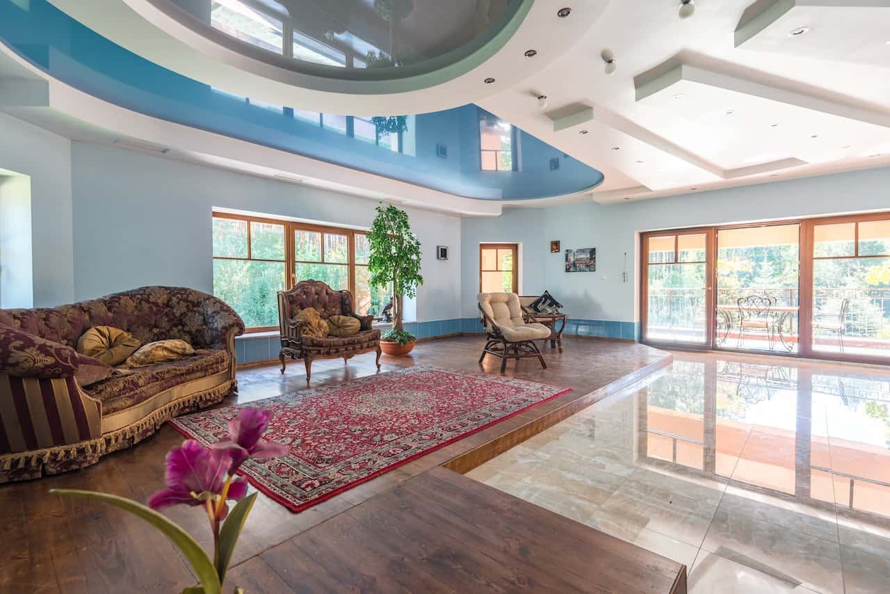 Fiber ceiling designs add elegance to this large living room with vintage decor