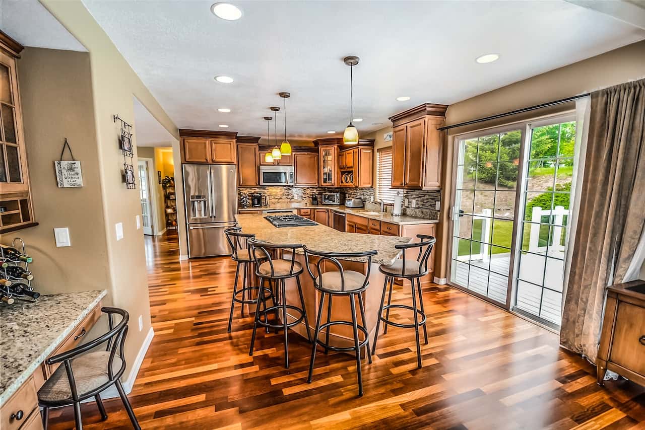 Modern kitchen with fiber ceiling designs and rich wooden flooring finish
