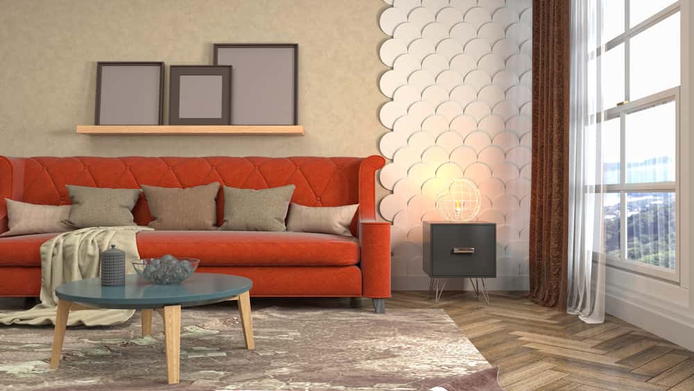 Living room with modern wall moulding designs and a bold red sofa against patterned wall