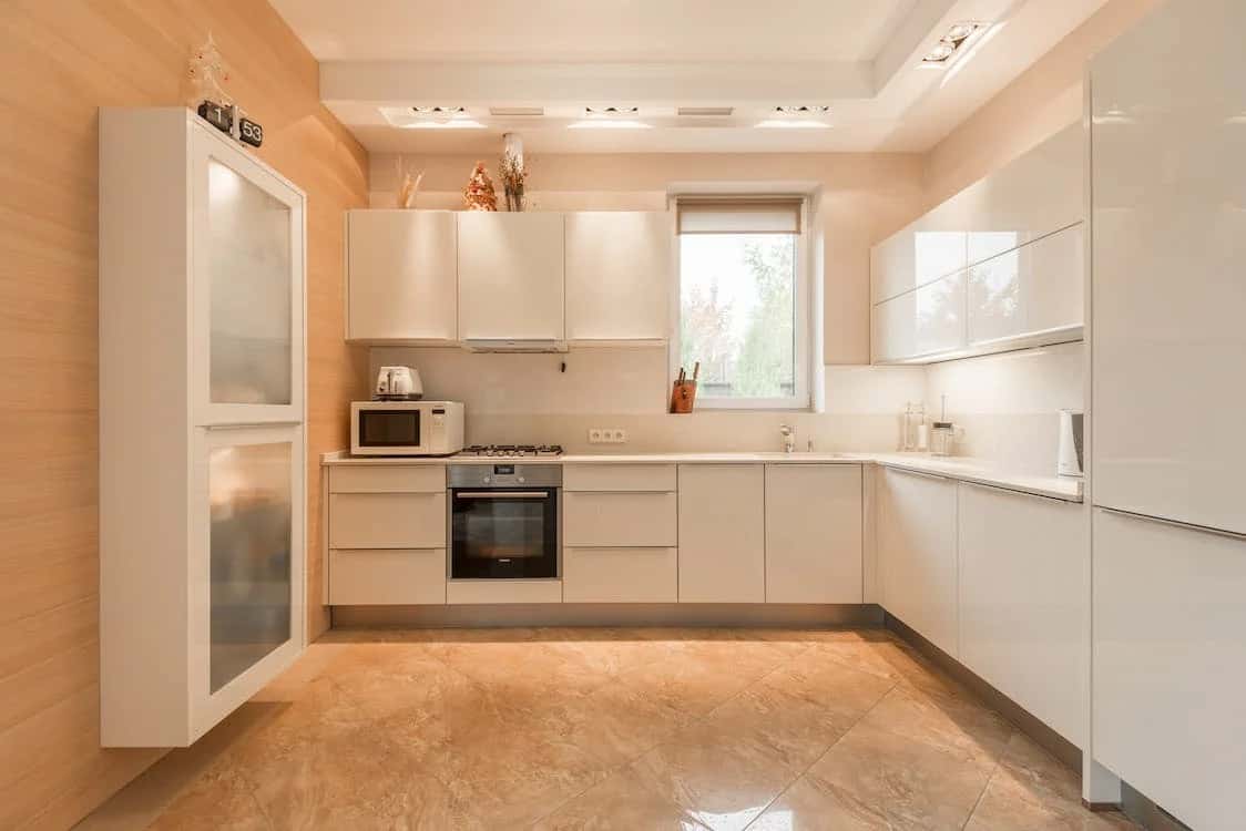 Contemporary cement cupboard designs with sleek white cabinets in kitchen