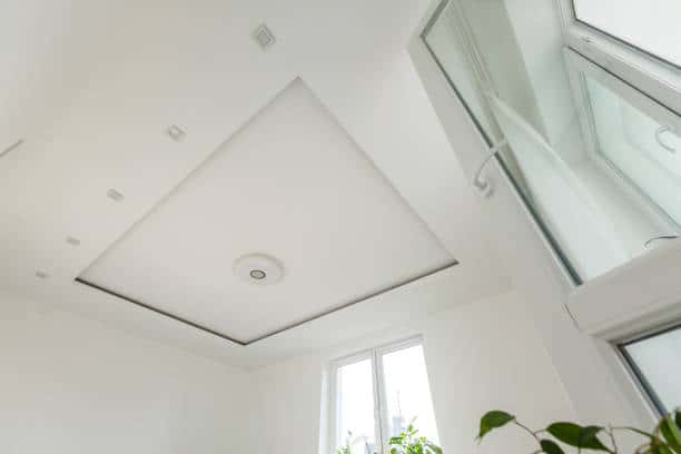 Minimalist glass ceiling design with recessed lighting in a bright white room