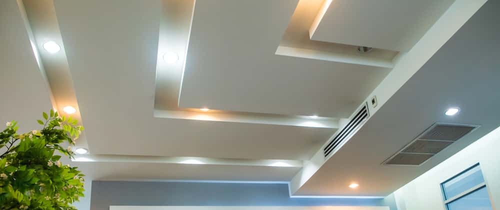 Glass false ceiling design with layered panels and soft ambient light effects