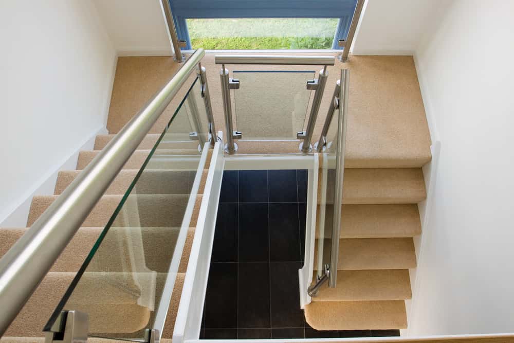 Modern glass railing designs for staircase with narrow landing