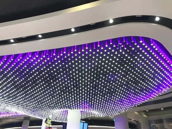 Modern glass ceiling design with LED light installation in purple and white