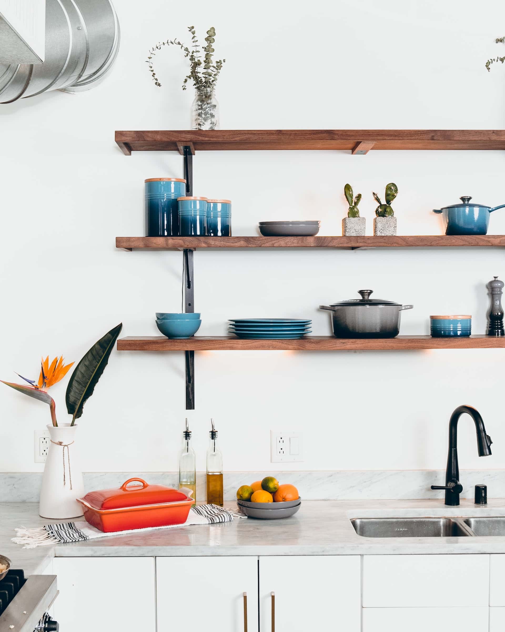 Stylish kitchen sink design with open wood shelves and setup
