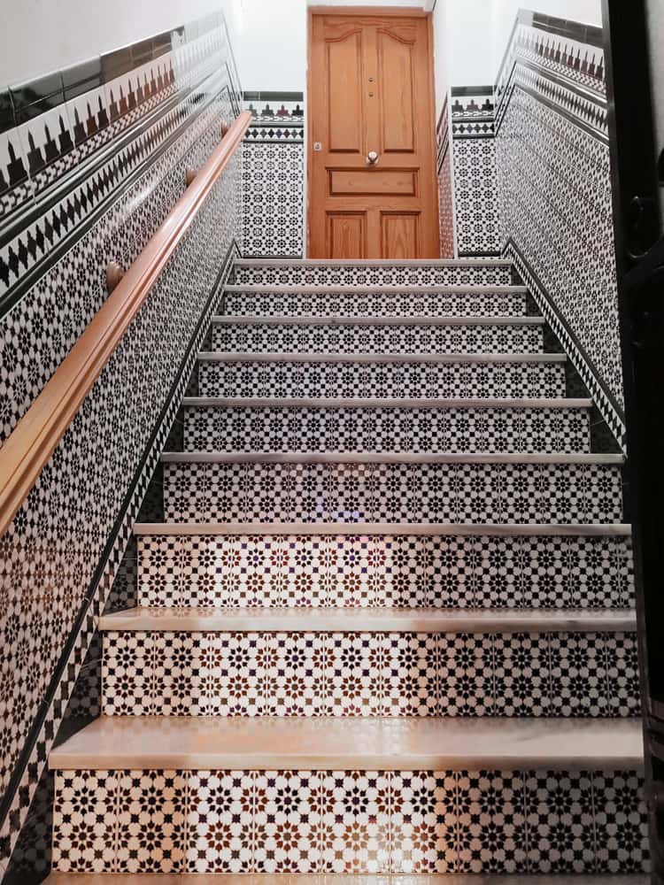 Ornate indoor staircase tile designs with classic geometric mosaic accents