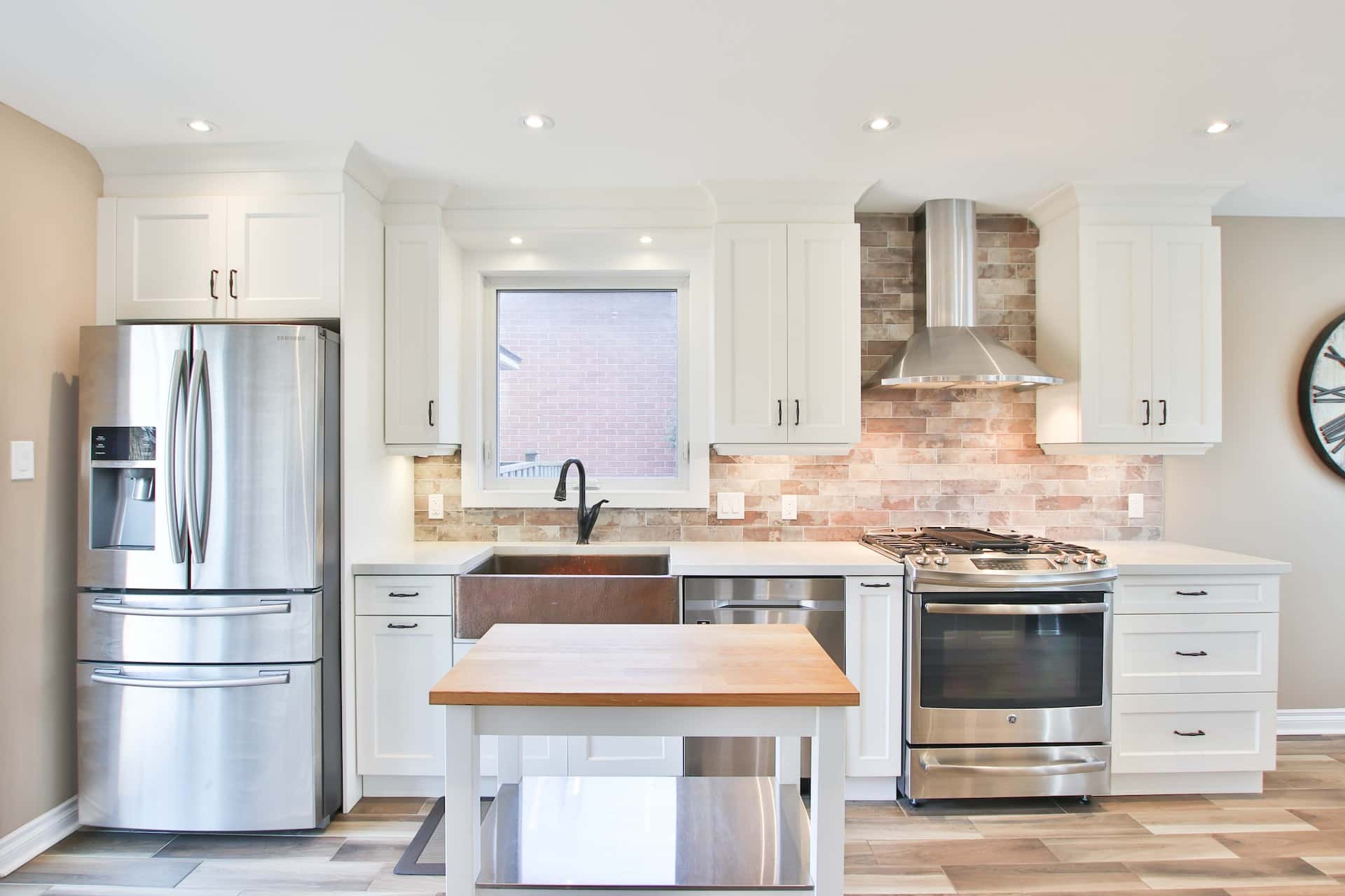 Modern kitchen sink design using white cabinets and copper basin