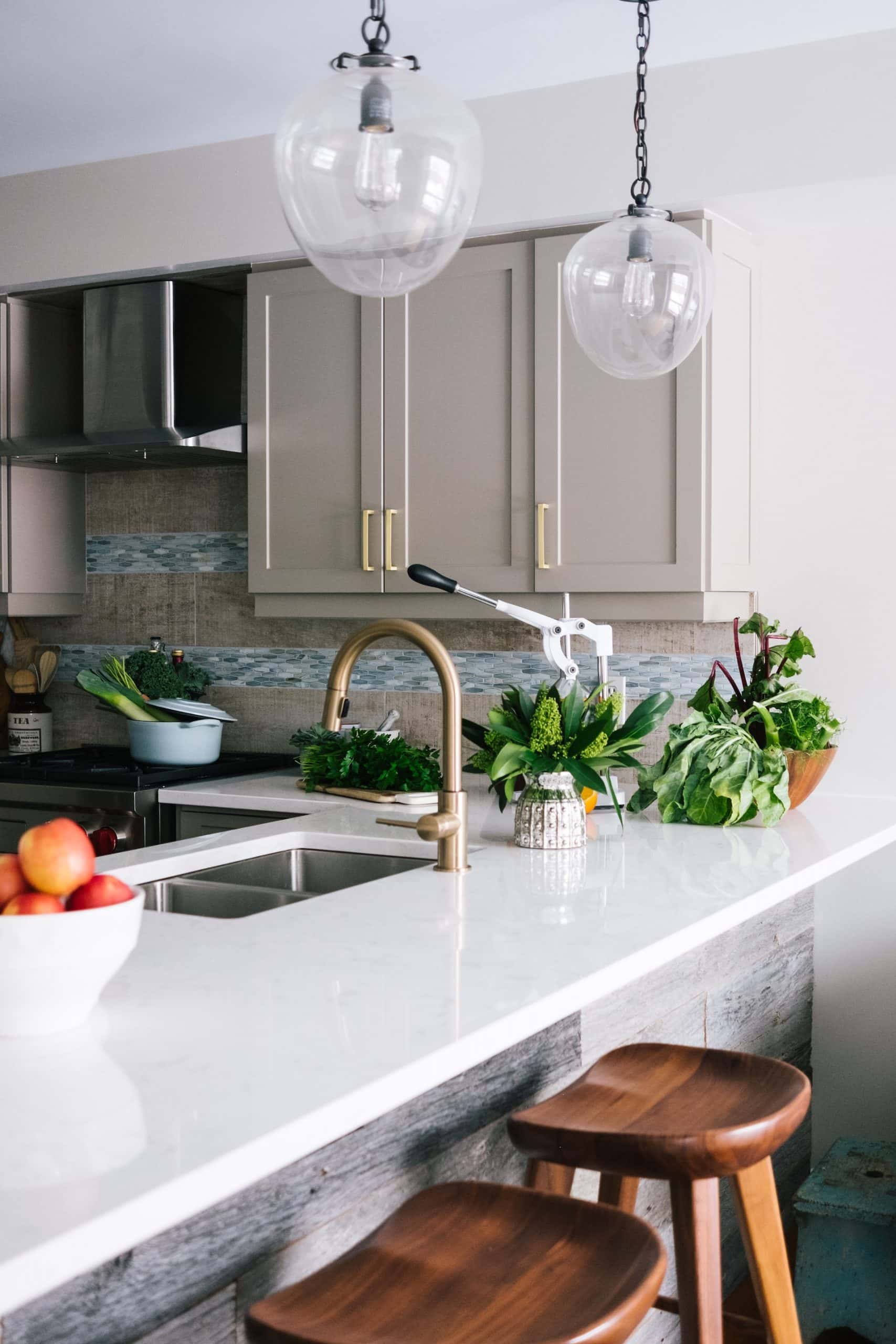 Stylish kitchen sink design with gold faucet and clean white counter
