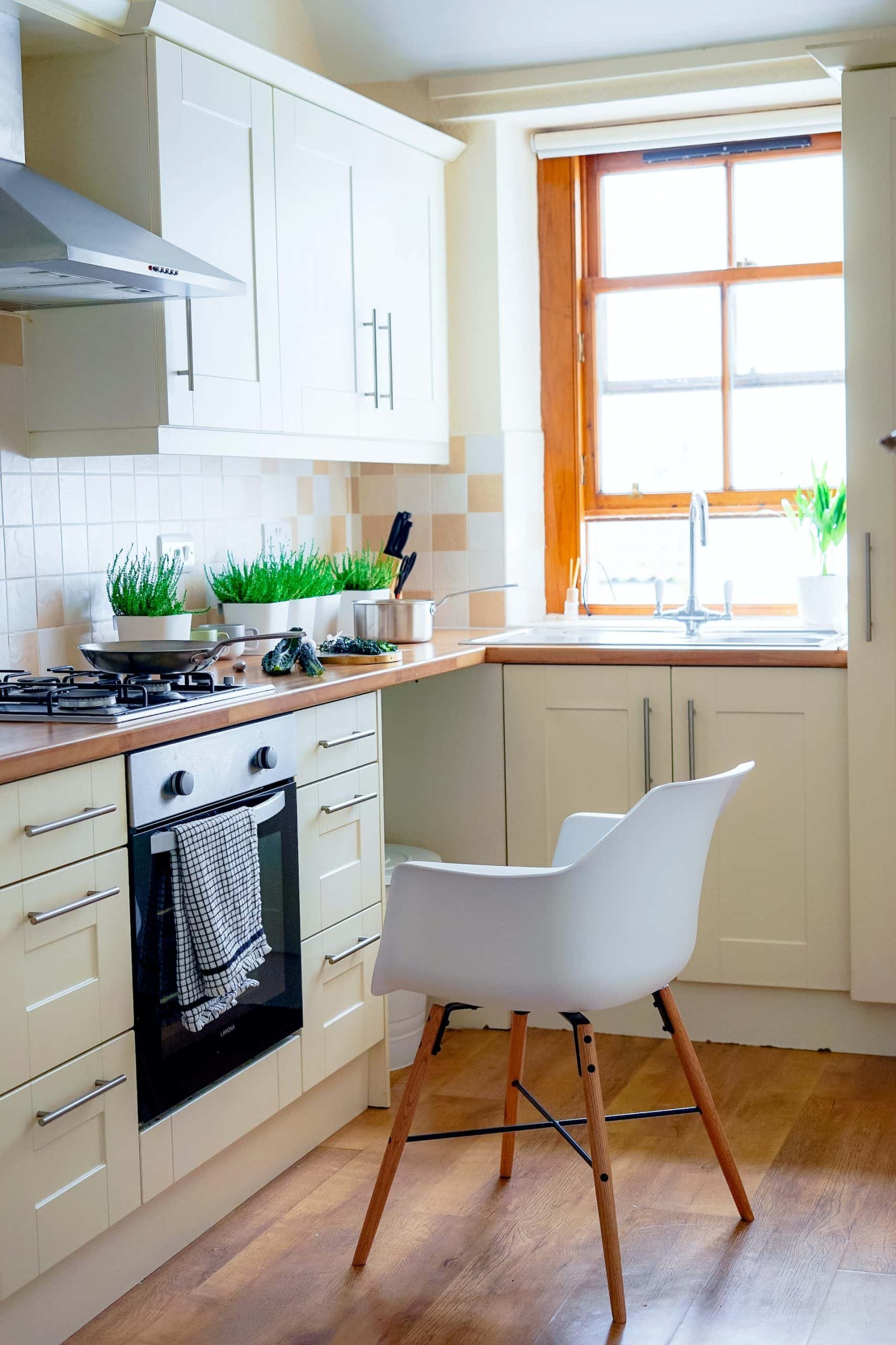 Simple kitchen sink design with window and natural wood counter