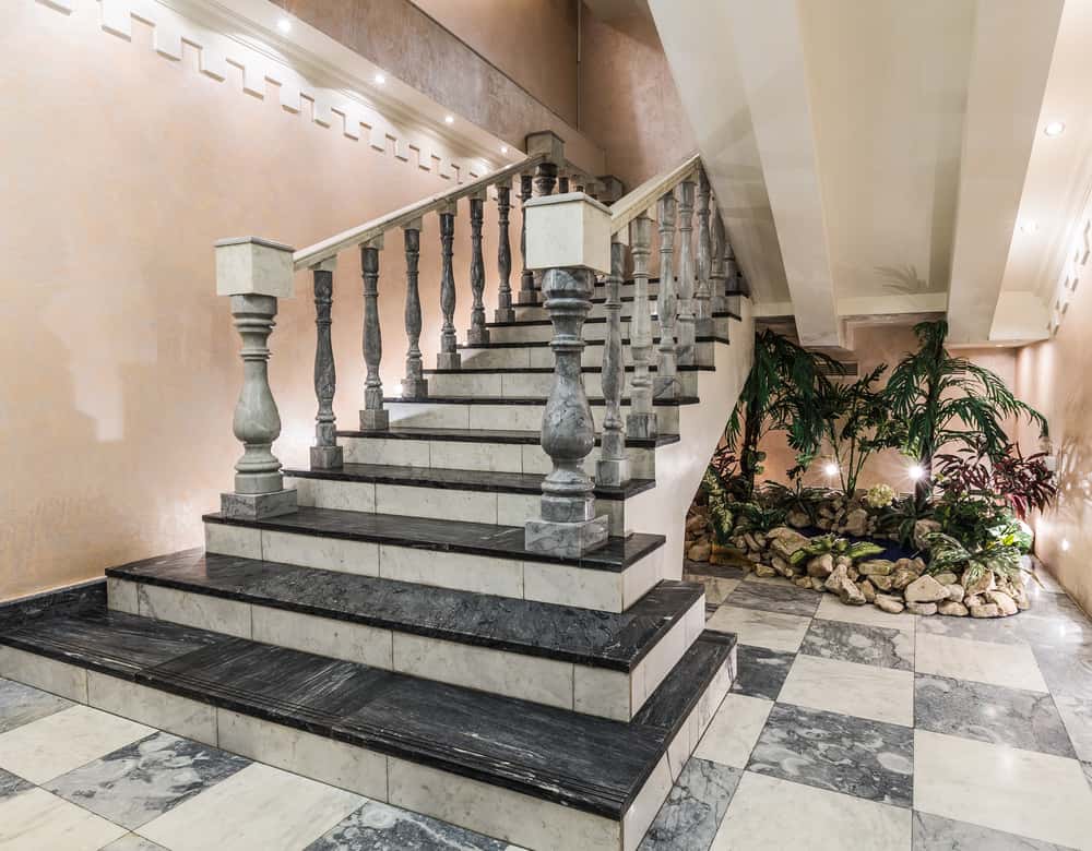 Elegant marble staircase tile designs elevate this luxury interior entry setting
