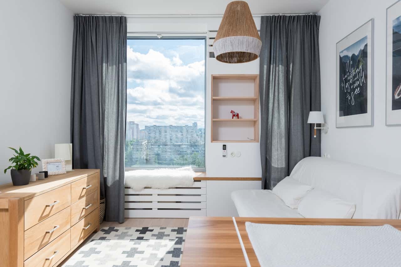 Modern cement cupboard designs with open shelves beside a window seat