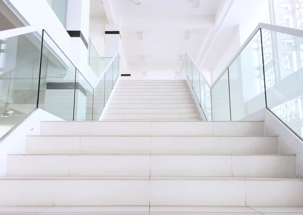 Interior staircase glass railing design with modern minimalist style