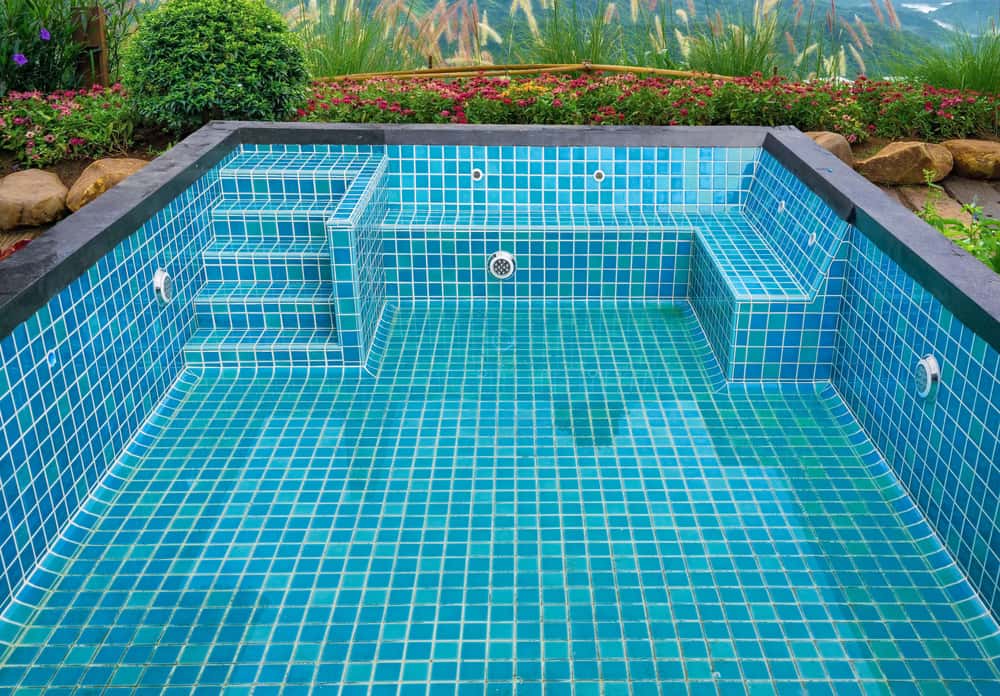 Poolside steps with outdoor staircase tile designs in vibrant aqua mosaic style