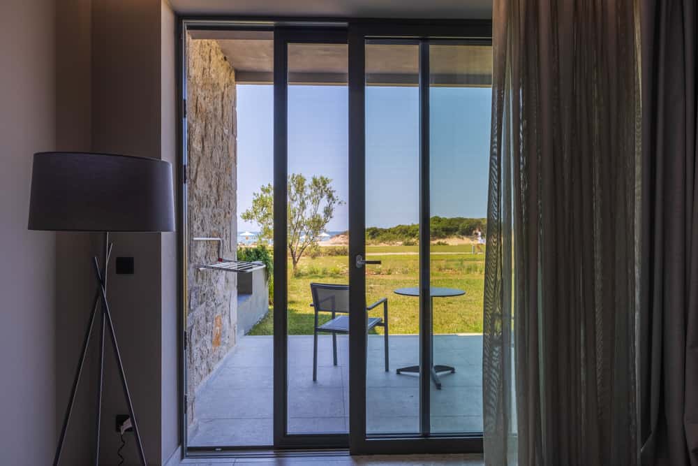 Elegant mosquito net door design overlooking scenic balcony view