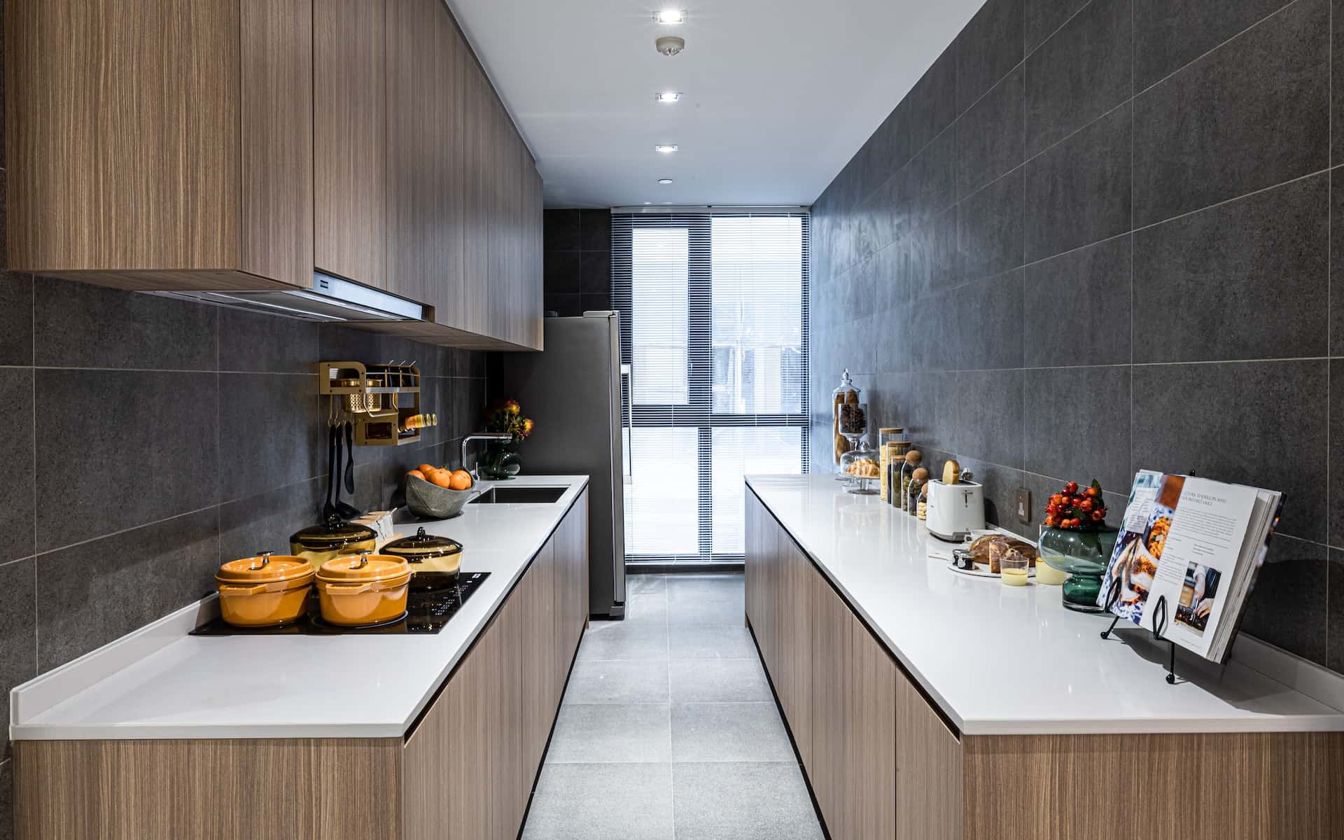 Galley sleek kitchen modular designs featuring wood cabinets white counters and dark walls