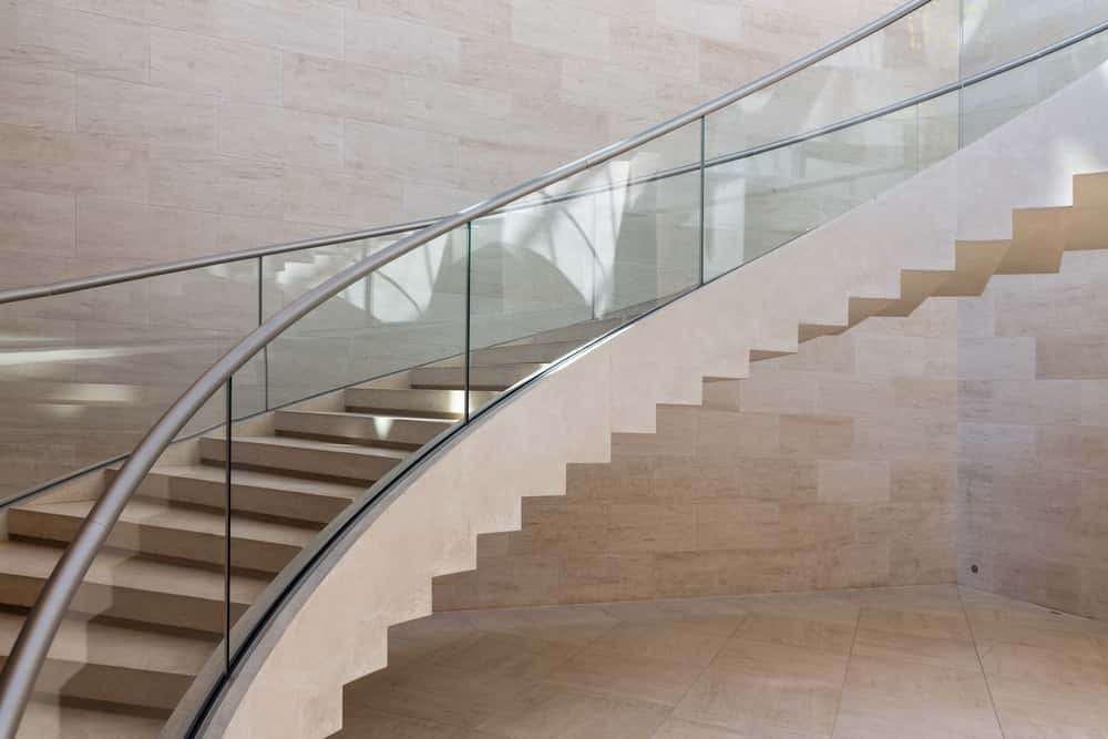 Curved staircase glass railing design with stainless steel handrail