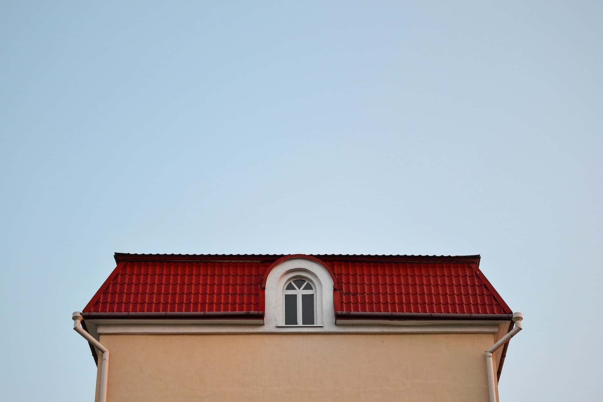 Elegant mangalore tile roof with bright red tiles and arched dormer window design