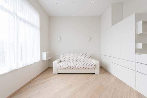 Minimalist cement cupboard designs with modern sofa in bright wooden floor hall