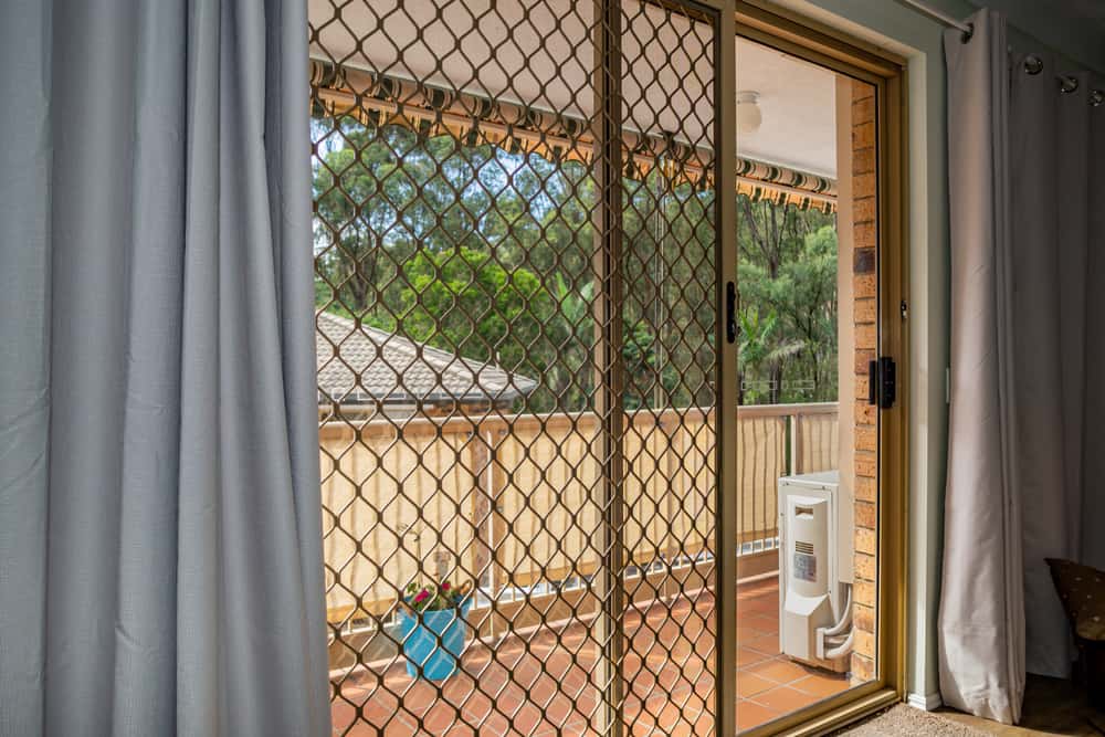 Spacious balcony sliding screen door designs for airy homes