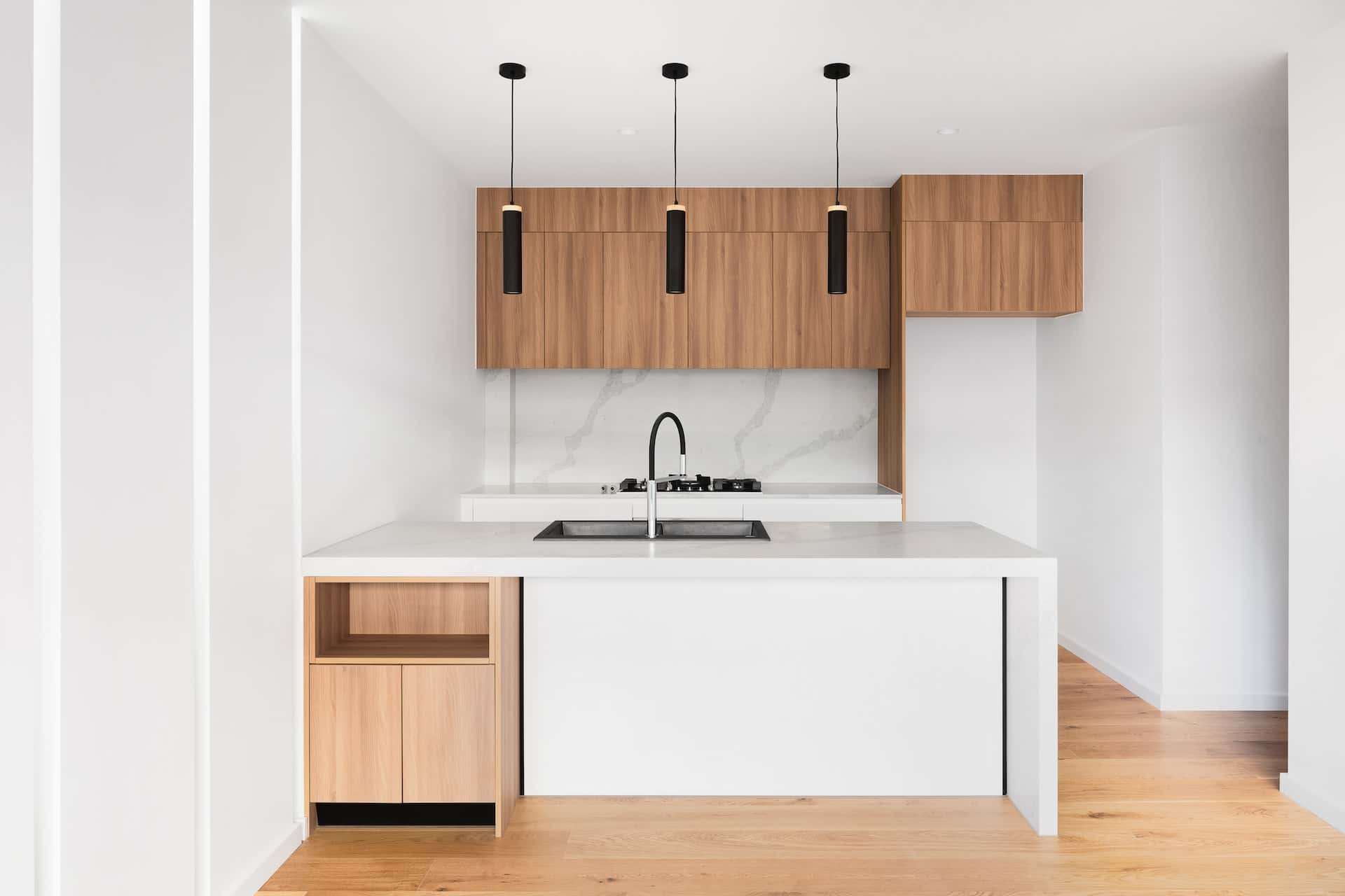 Minimal sleek kitchen modular designs with wood cabinetry white counters and pendant lights