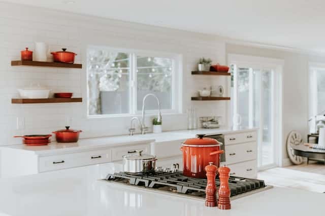 Smart small kitchen design with floating shelves and brick walls