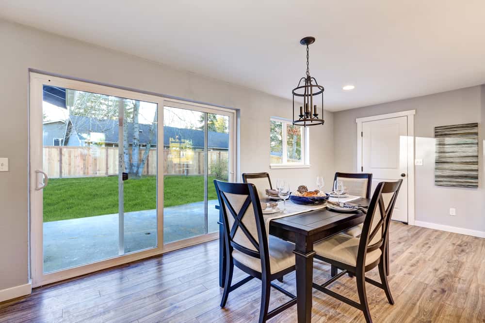 Dining space sliding mosquito net door design to backyard