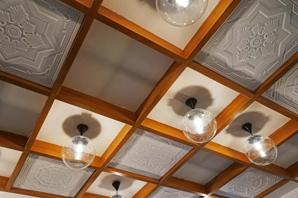Elegant glass ceiling design with wooden grid frame and decorative panels
