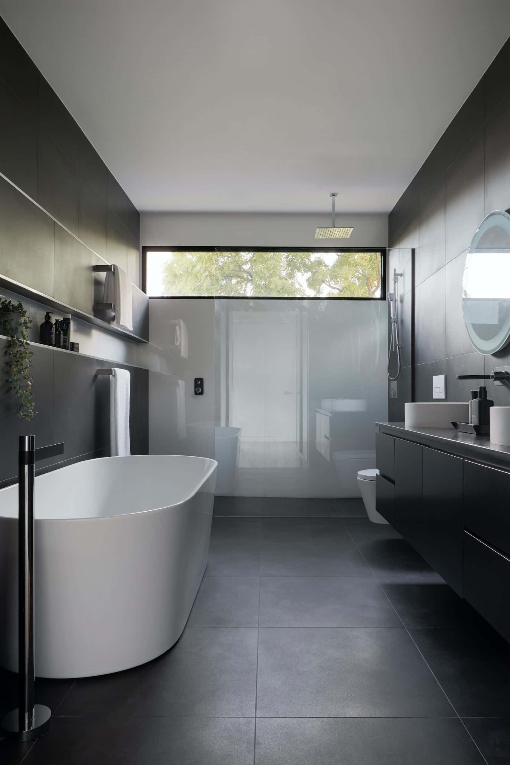 white tub and black tiles