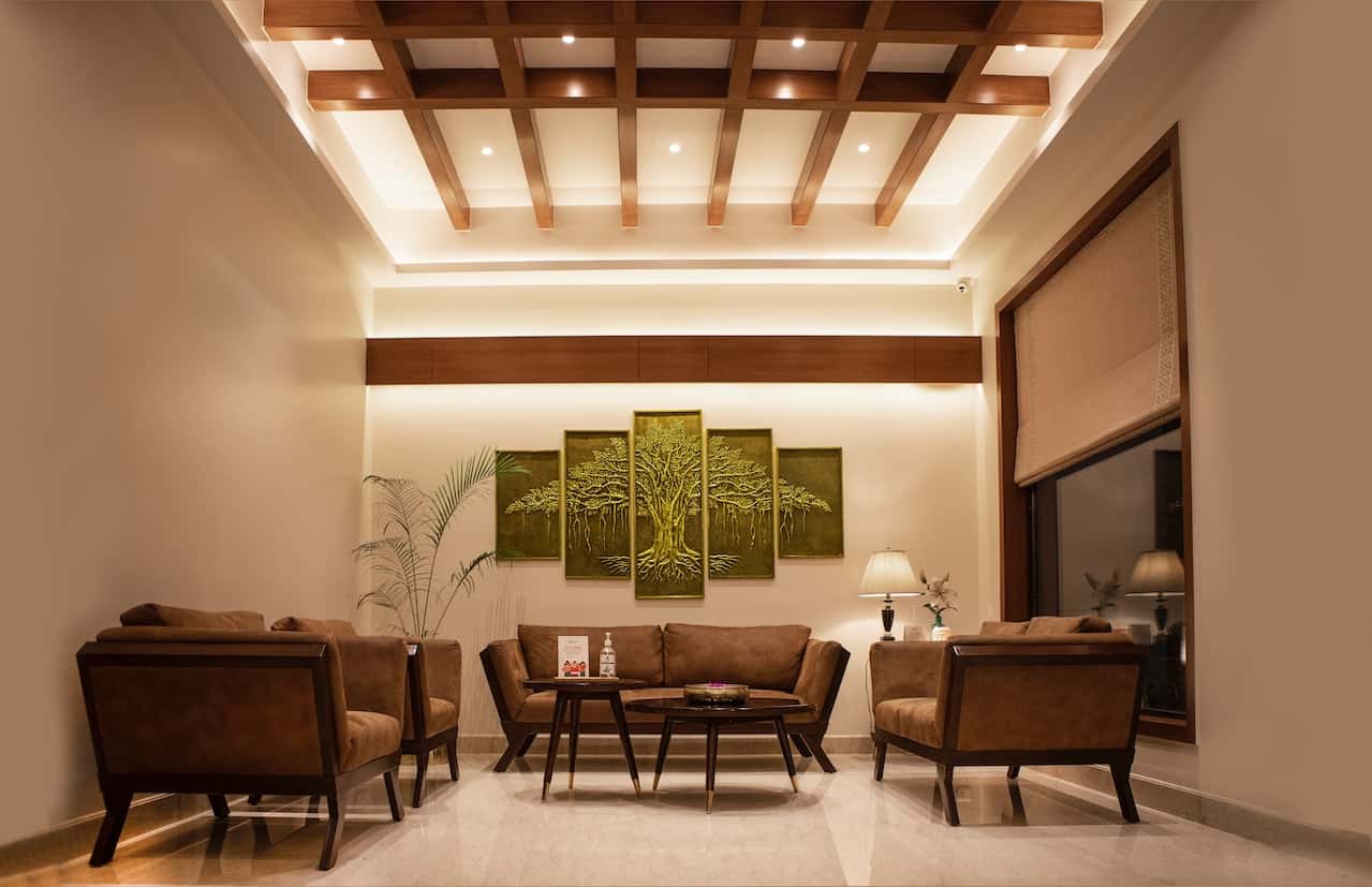 Modern fiber ceiling designs elevate this luxurious living room with warm lighting