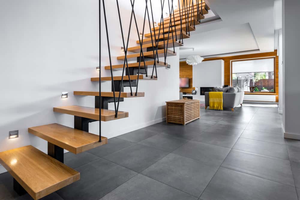 Floating wood modern staircase tile designs in a sleek, open-concept interior