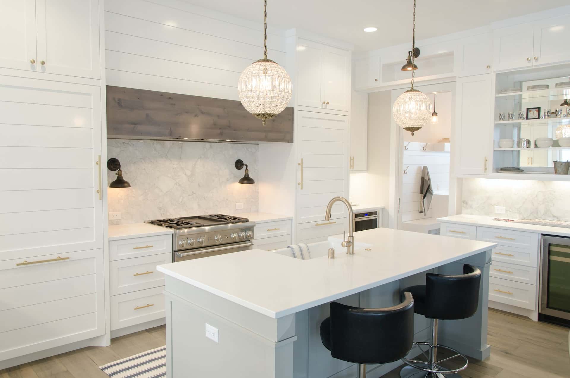 Elegant 3D kitchen design featuring white shiplap, marble, and crystal pendants.