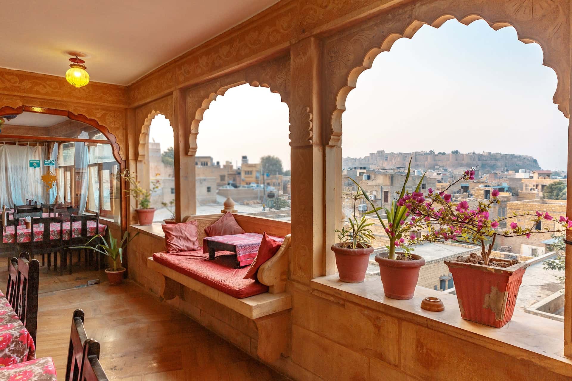 Traditional haveli designs with carved arches and a scenic rooftop view