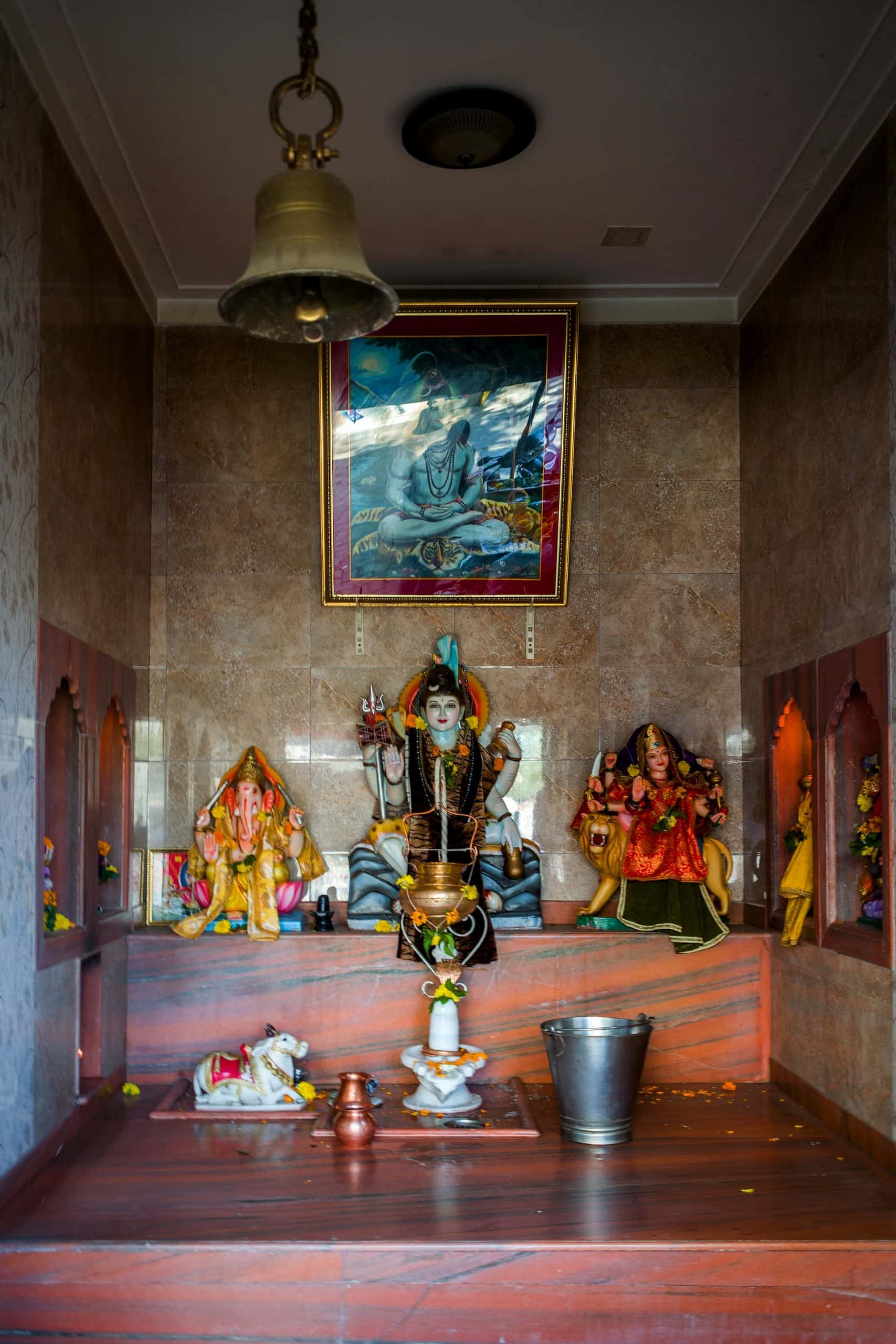Traditional mandir door designs with idols and divine pooja room setting