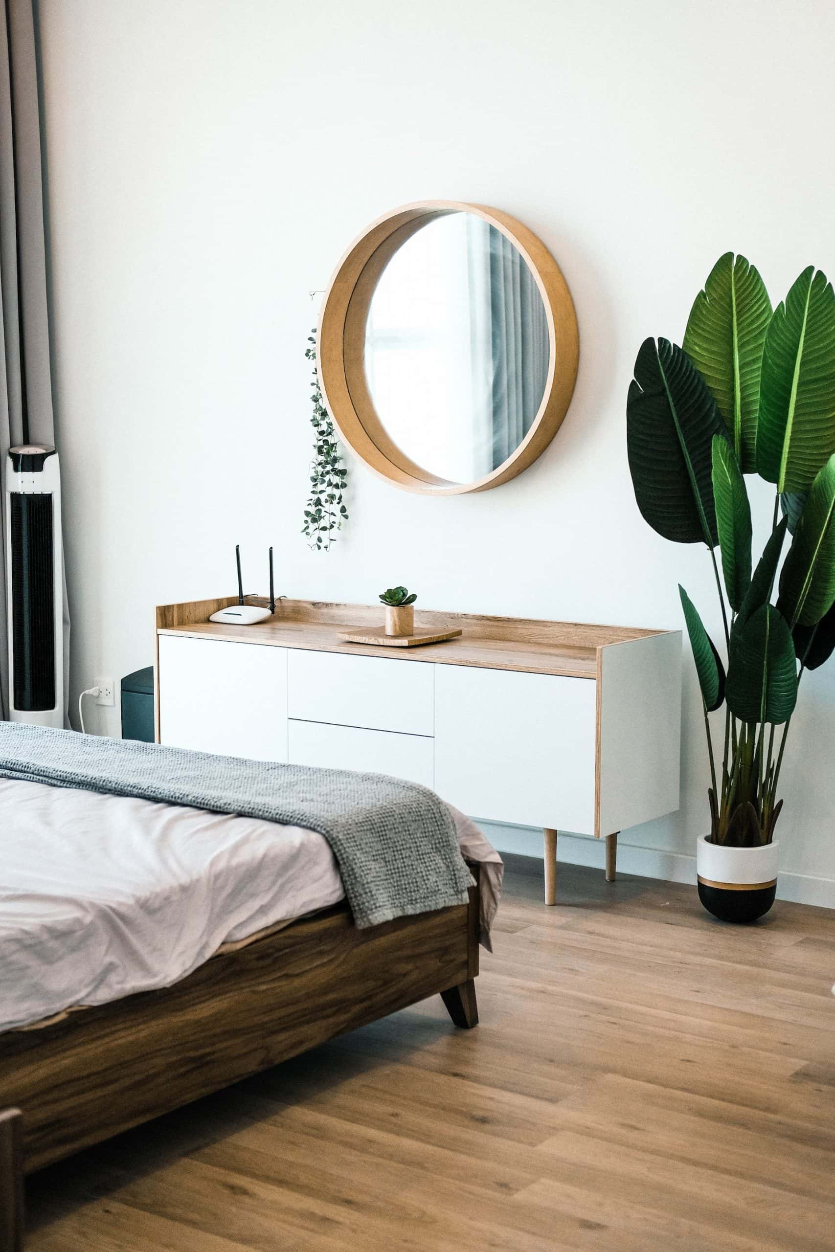 Cozy bedroom interior mirror design with wooden frame and indoor plant