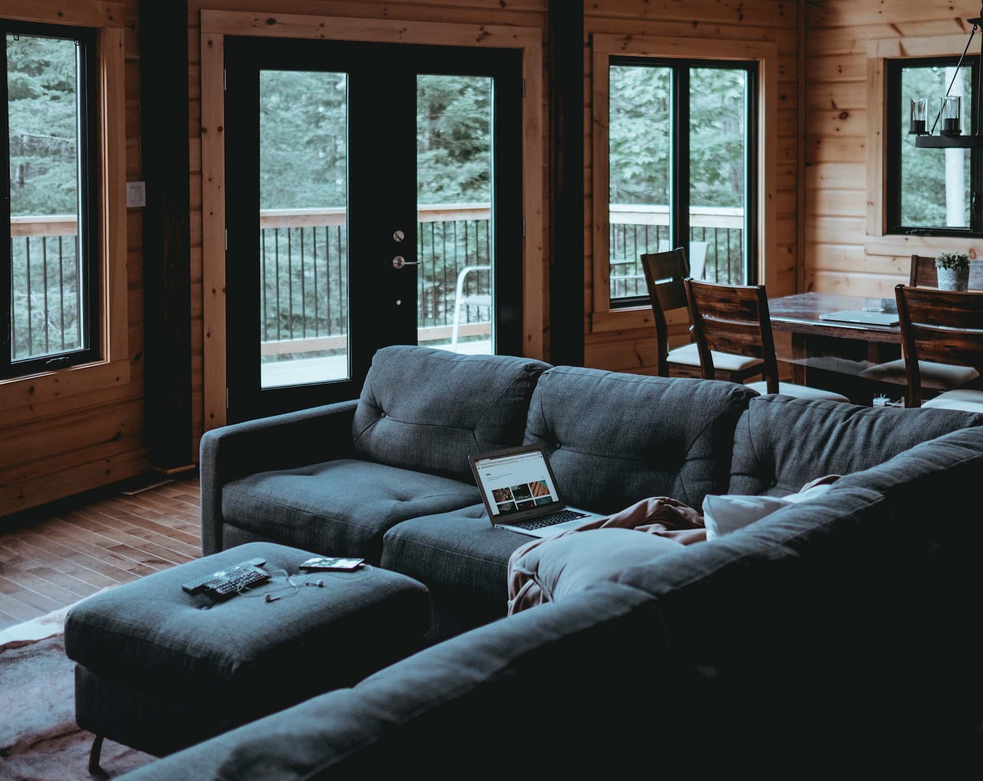 Warm assam type house design interior with wooden walls and cozy grey sofa