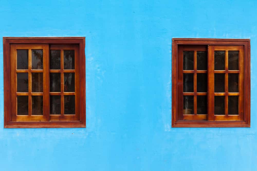 traditional wooden window design with a grill